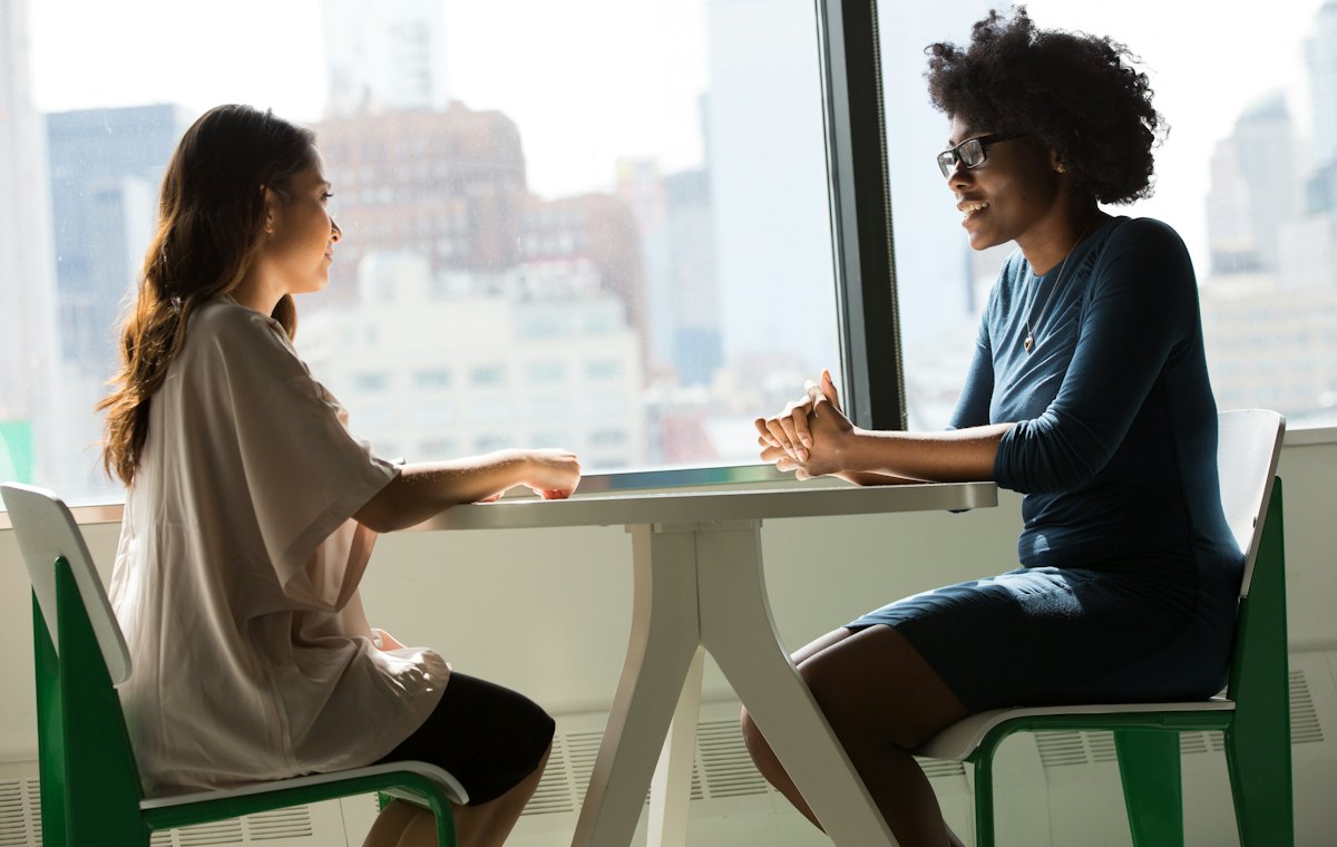 Two people sitting across a table in conversation