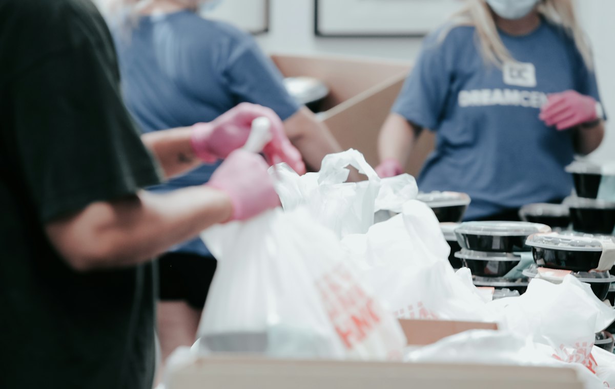 Volunteers packing food parcels into bags